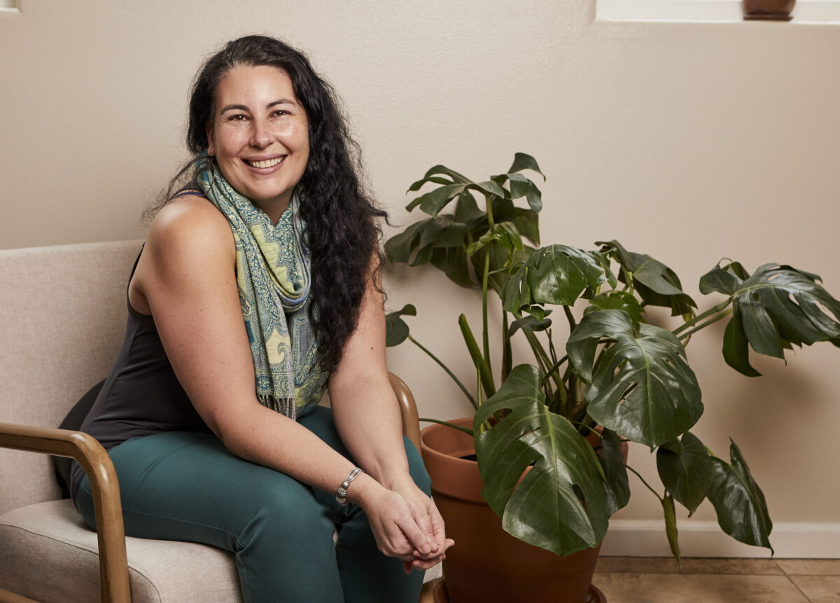 photo of amanda, a white woman with long brown hair. She's sitting and smiling warmly at the camera.